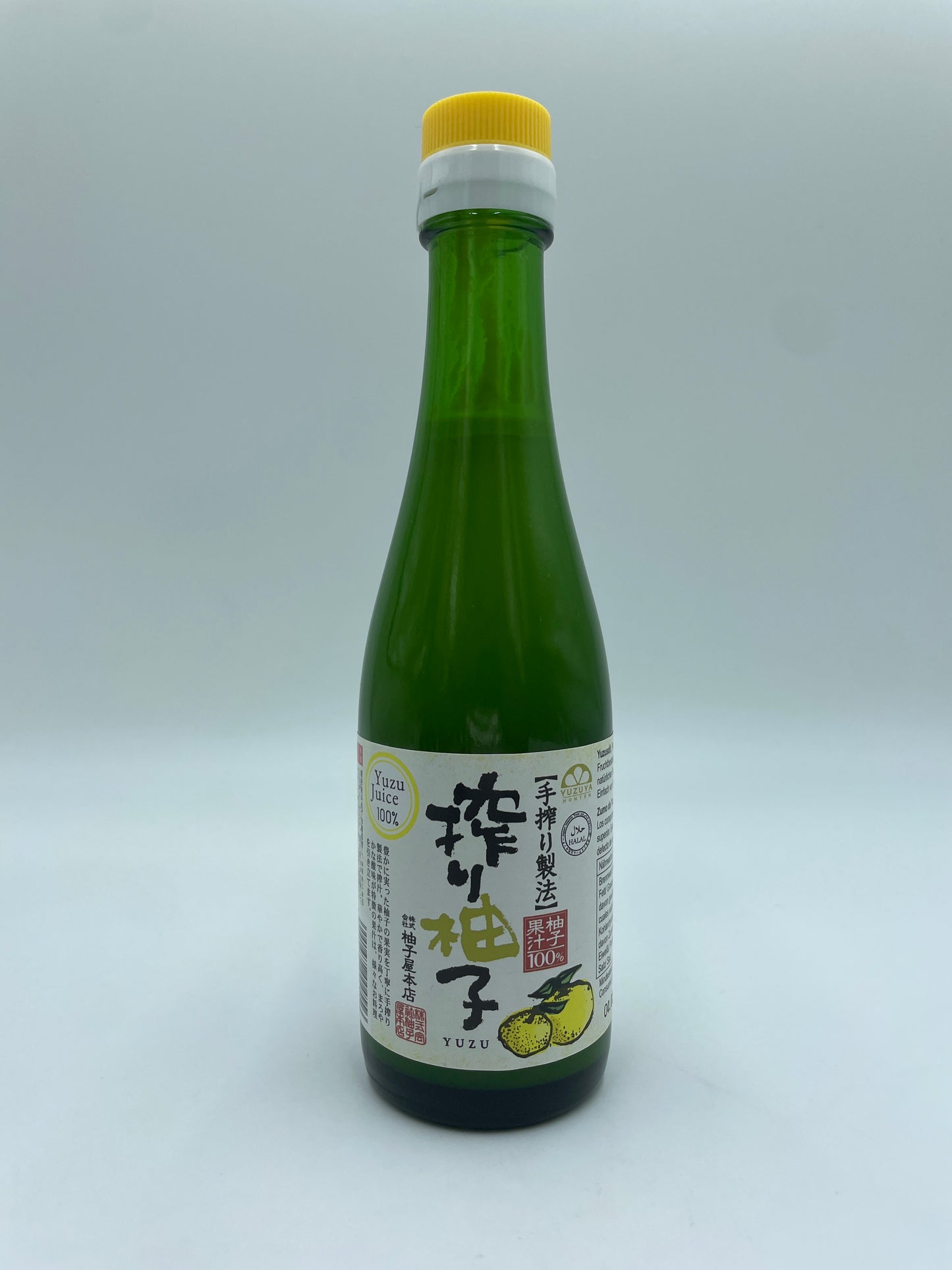 Yuzu Juice 100 % fra YUZUYA HONTEN i konservet form, vises i flaske med gul Yuzu frugt og etikette.