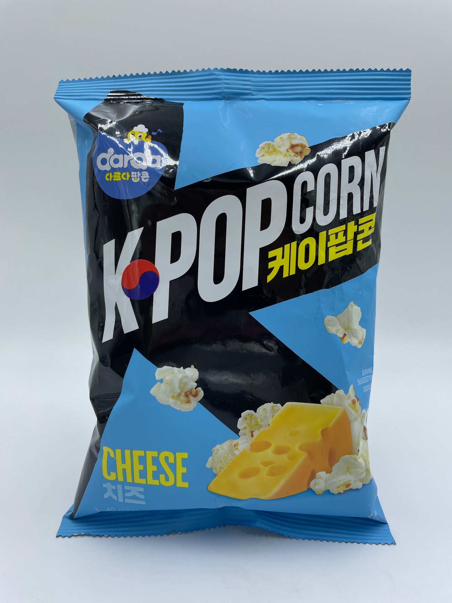 K-popcorn med ost fra DARDA, sprød snacks med ostesmag, vist i en åben pose med gyldne popcorn.